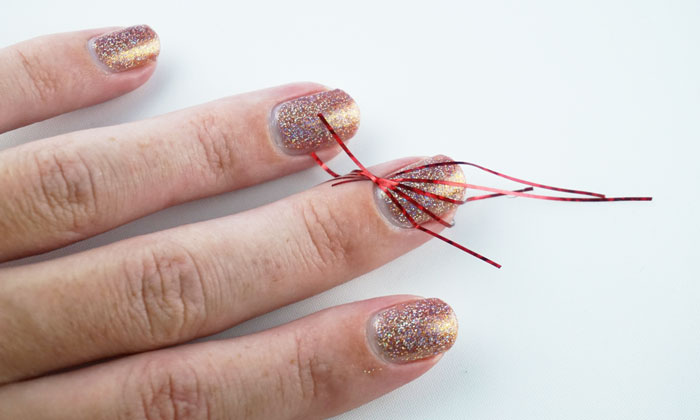 Nails with striping time on them, that are about to get painted to create a nail art